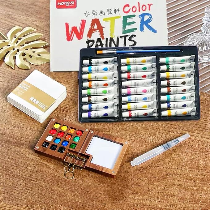 Mini Watercolor Paint Set, Mini Watercolor Travel Set with 1 Wooden 15-Grid Palette, 24 Colors Paint, 1 Sketch Books and 1 Brushes, Copper Clip and Sketchbook for Travel Painting